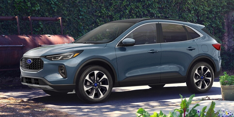 Blue SUV parked outdoors near greenery